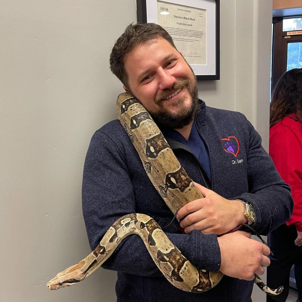 dr sam holding a snake